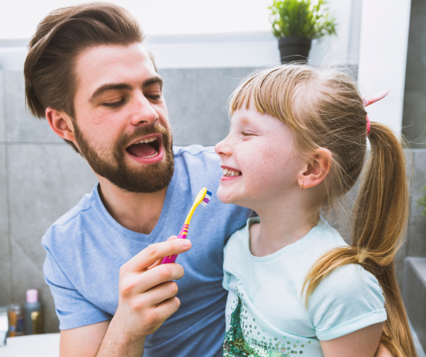 Dad playfully brushing teeth
